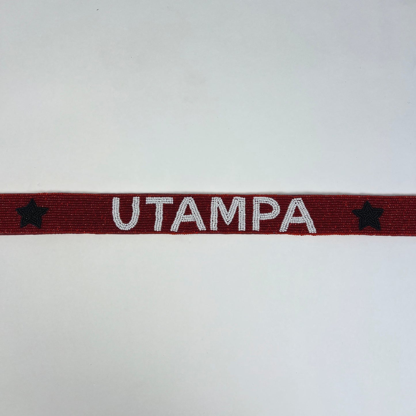 Red band with 'UTAMPA' text and stars on a white background