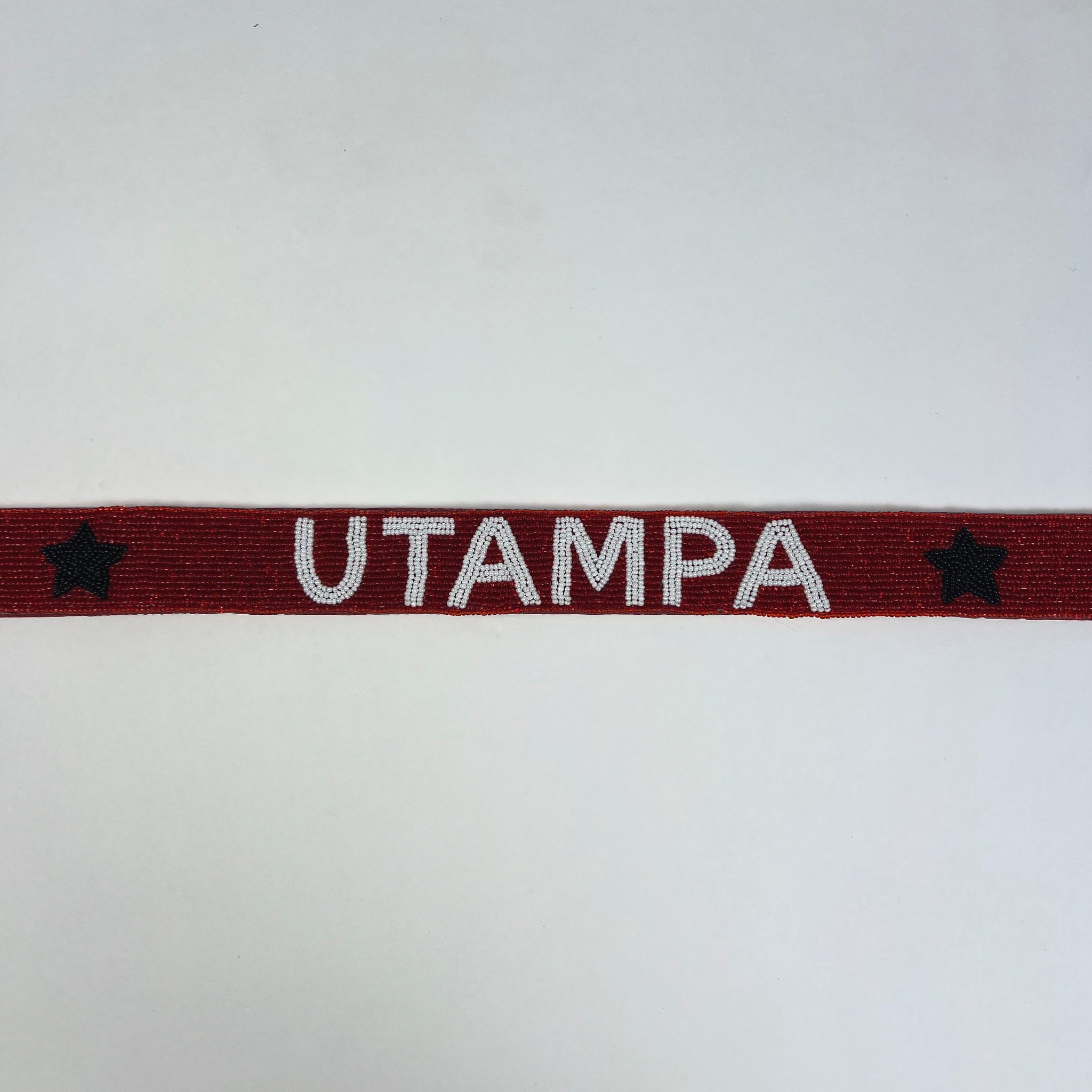 Red band with 'UTAMPA' text and stars on a white background