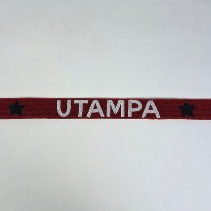 Red band with 'UTAMPA' text and stars on a white background