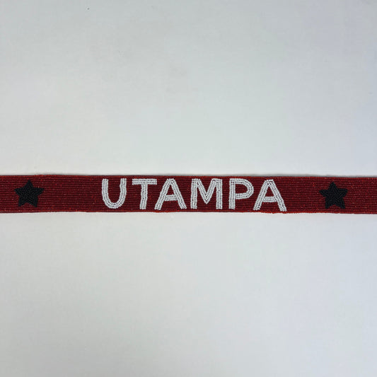 Red band with 'UTAMPA' text and stars on a white background